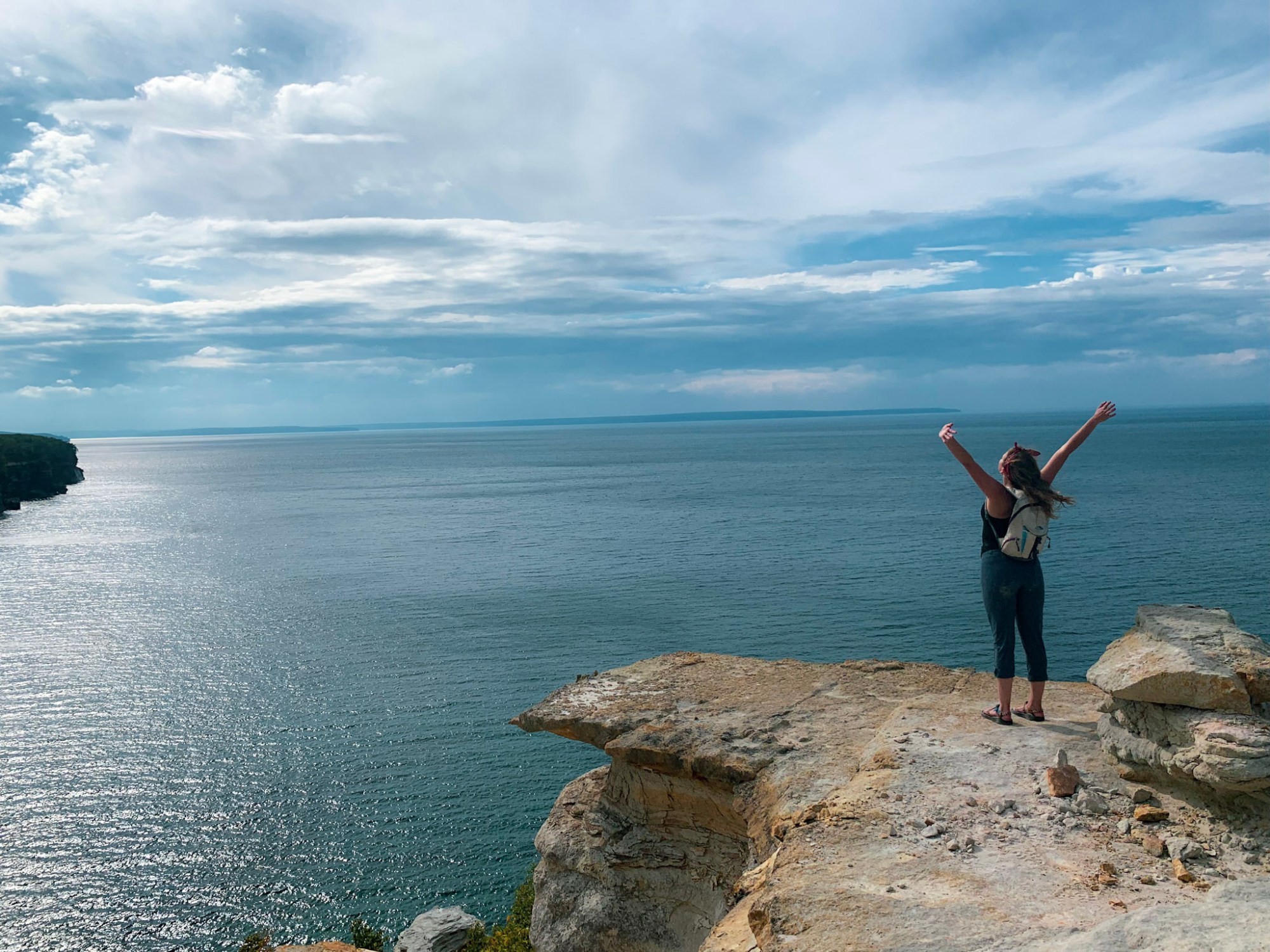 Kate spreading her arms over the lake michigan